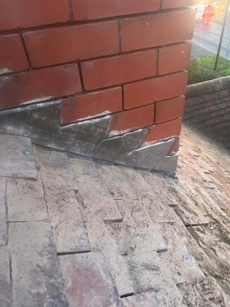 This is a photo of new leadwork being installed around an old chimney. Works carried out by Bloxwich Roofing Repairs